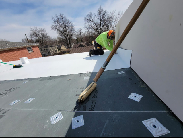 A roof being worked on by roofers.